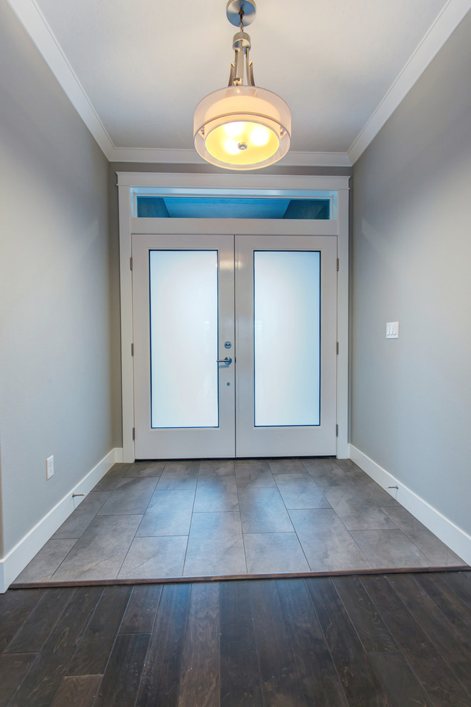 Example of a small transitional porcelain tile and beige floor entry hall design in Seattle with gray walls and a white front door