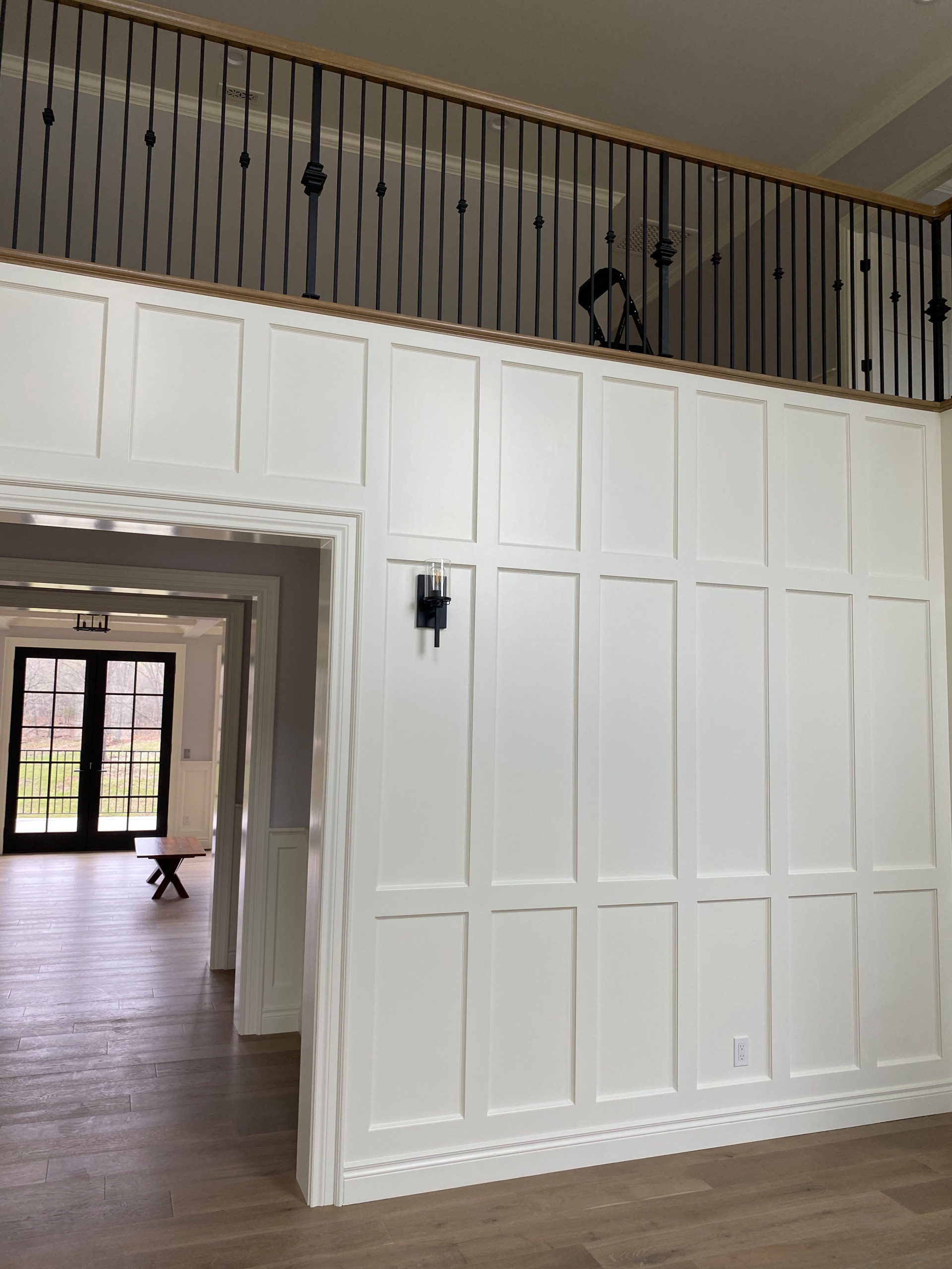 Balcony from entryway point of view (white painted wainscoting in entry)