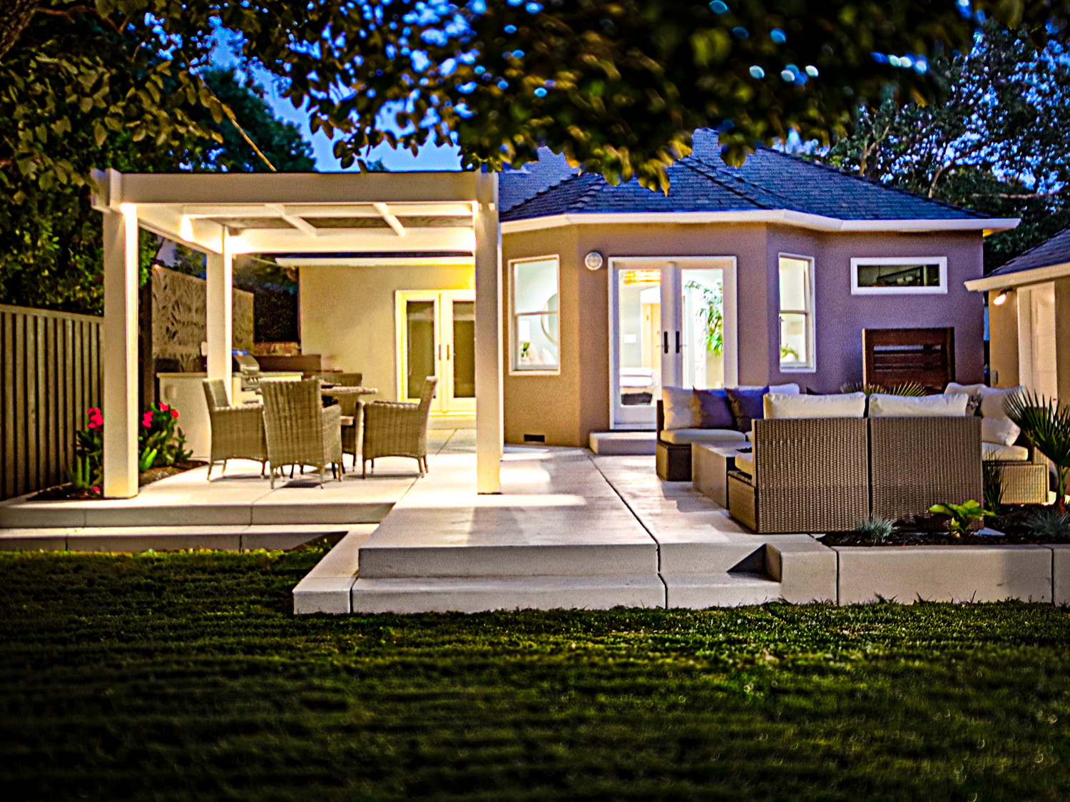 Inviting Raised Patio with Custom Pergola and Gate