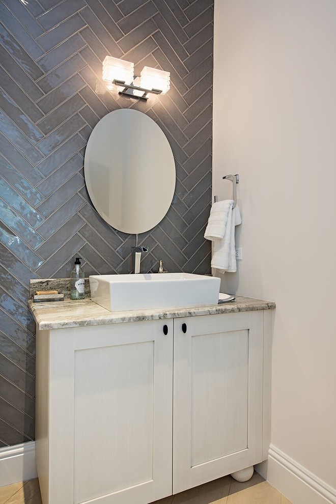 This is an example of a small contemporary 3/4 bathroom in Miami with furniture-like cabinets, white cabinets, a one-piece toilet, gray tile, stone tile, beige walls, terra-cotta floors, a console sink, limestone benchtops and beige floor.