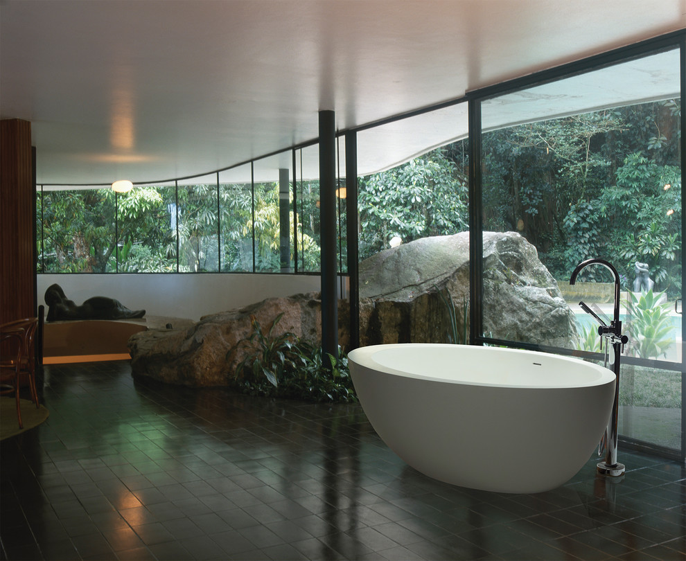 Photo of a mid-sized tropical master bathroom in Other with a freestanding tub, white walls and ceramic floors.