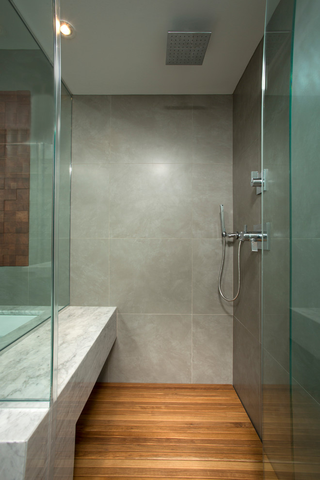 This is an example of a mid-sized contemporary master bathroom in DC Metro with a console sink, marble benchtops, an undermount tub, a curbless shower, gray tile, porcelain tile, grey walls and porcelain floors.
