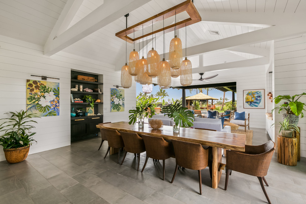 Large beach style open plan dining in Hawaii with white walls, porcelain floors, no fireplace and grey floor.