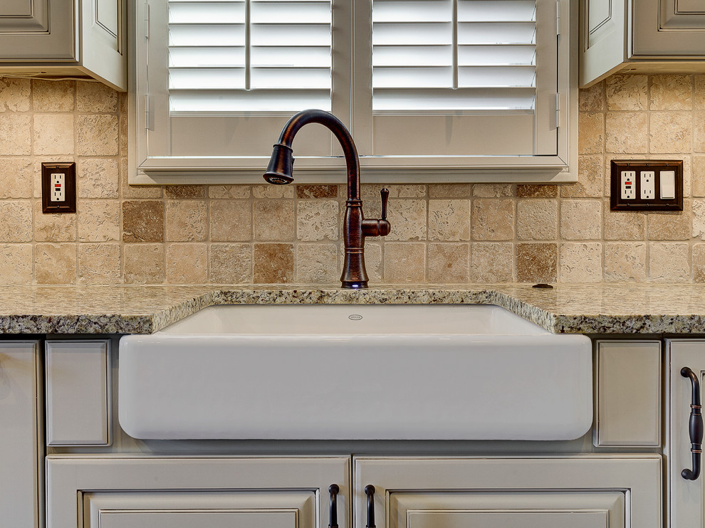 Mountain style eat-in kitchen photo in Columbus with a farmhouse sink, flat-panel cabinets, white cabinets, marble countertops, beige backsplash, stone tile backsplash and stainless steel appliances
