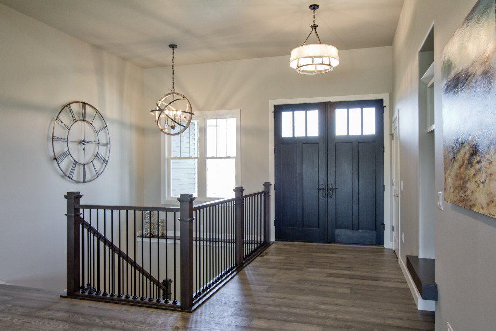 Inspiration for a transitional medium tone wood floor and brown floor double front door remodel with a dark wood front door