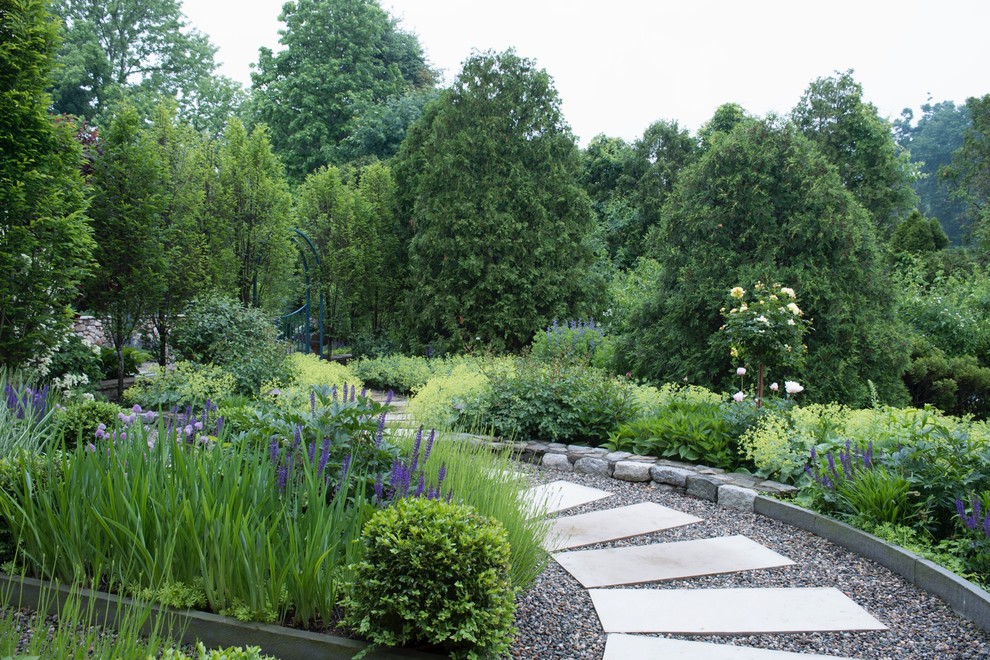 Photo of a traditional full sun garden in New York with a garden path and concrete pavers.