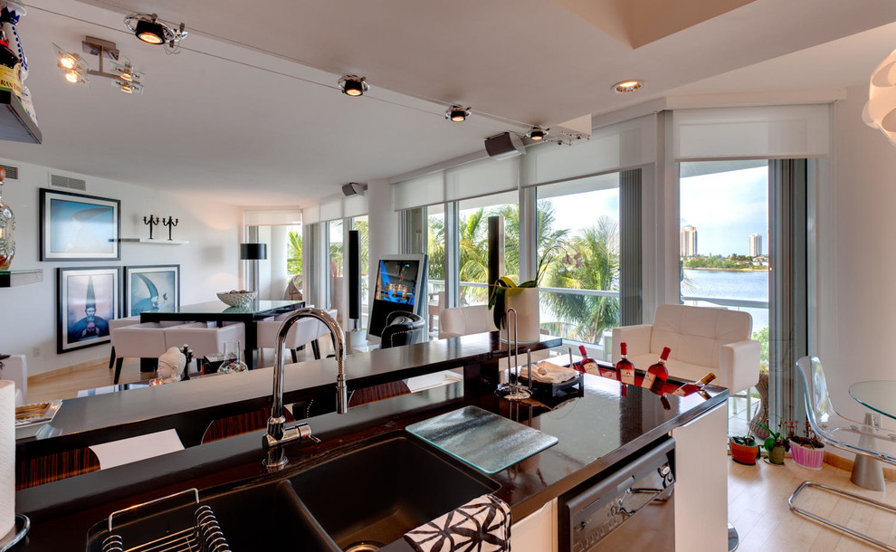 This is an example of a mid-sized modern l-shaped eat-in kitchen in Miami with a double-bowl sink, wood benchtops, brown splashback, mosaic tile splashback, coloured appliances, light hardwood floors and a peninsula.