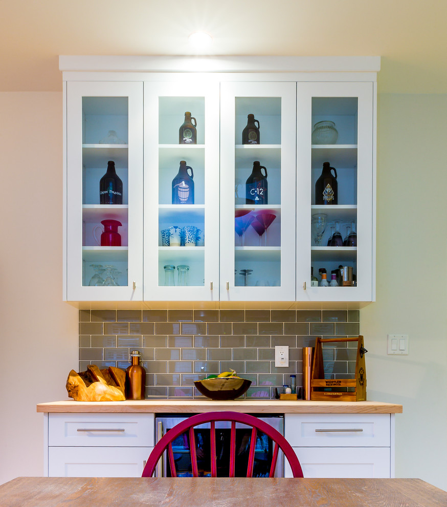 Inspiration for a large transitional u-shaped light wood floor open concept kitchen remodel with a farmhouse sink, shaker cabinets, blue cabinets, quartz countertops, gray backsplash, glass tile backsplash, stainless steel appliances, an island and white countertops