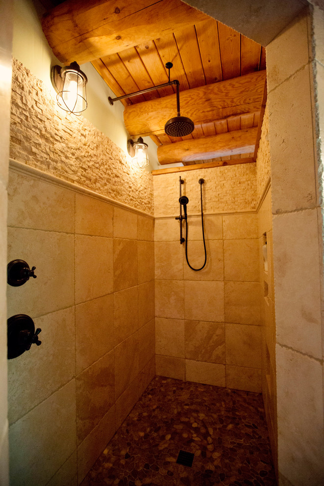 This is an example of a mid-sized country master bathroom in Chicago with a corner shower, brown tile, ceramic tile, pebble tile floors, brown floor and an open shower.