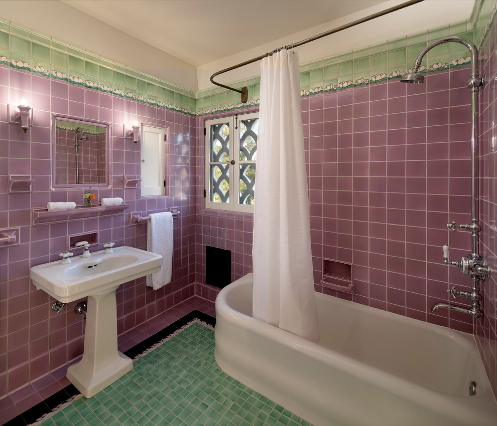 This is an example of a small mediterranean master bathroom in Los Angeles with a corner tub, a shower/bathtub combo, multi-coloured tile, ceramic tile, purple walls, ceramic floors and a pedestal sink.