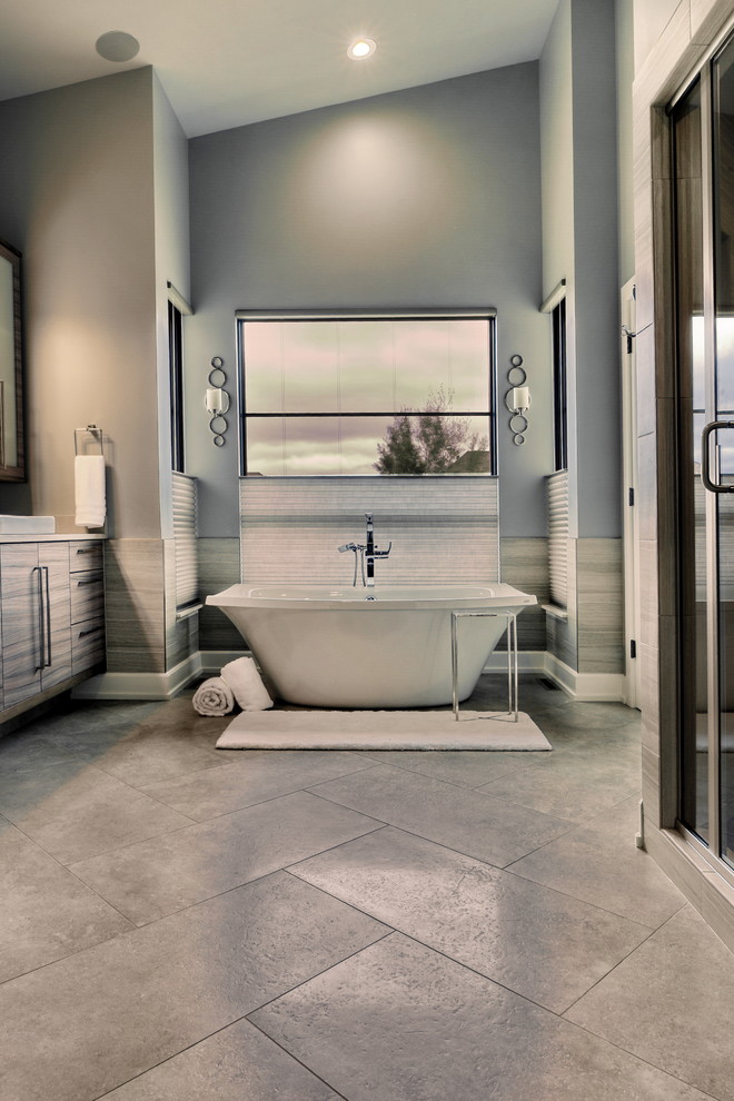 Design ideas for a large midcentury master bathroom in Omaha with flat-panel cabinets, grey cabinets, a freestanding tub, an alcove shower, a two-piece toilet, blue tile, porcelain tile, blue walls, porcelain floors, a drop-in sink, solid surface benchtops, grey floor, a hinged shower door and beige benchtops.