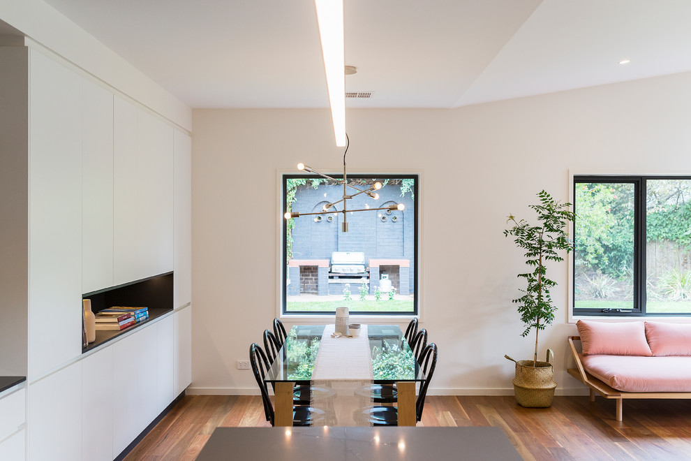 Inspiration for a contemporary open plan dining in Canberra - Queanbeyan with light hardwood floors, white walls and brown floor.