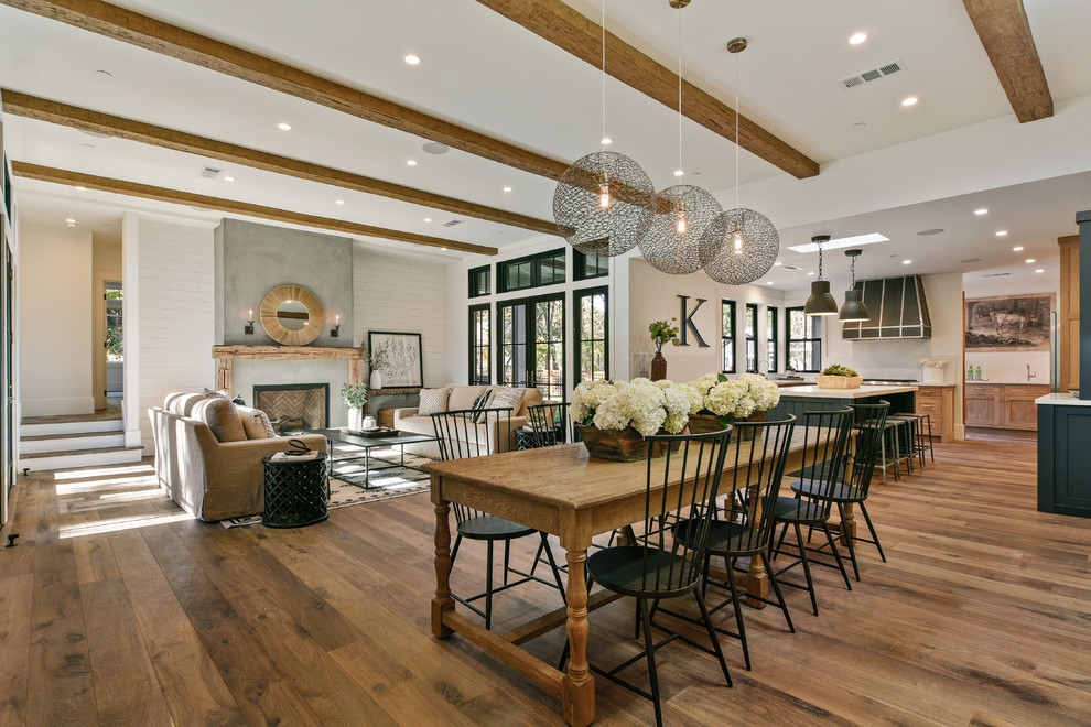 Inspiration for a transitional open plan dining in San Francisco with white walls, medium hardwood floors and no fireplace.
