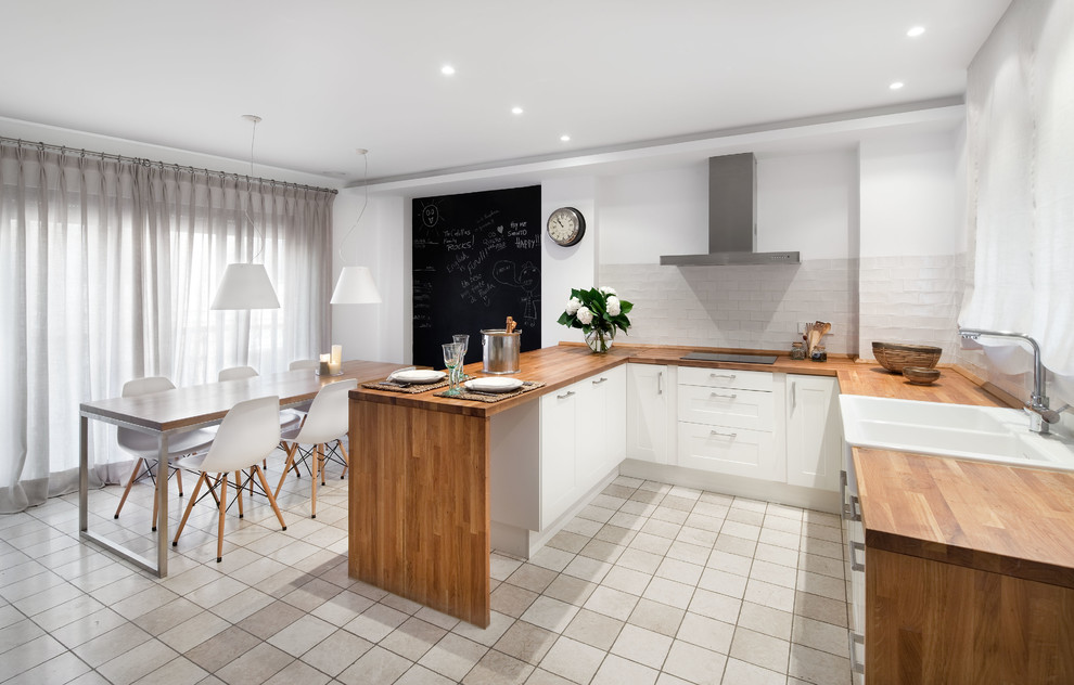 Inspiration for a mid-sized contemporary u-shaped open plan kitchen in Other with flat-panel cabinets, light wood cabinets, wood benchtops, white splashback, ceramic splashback, white appliances, ceramic floors, a peninsula and white floor.