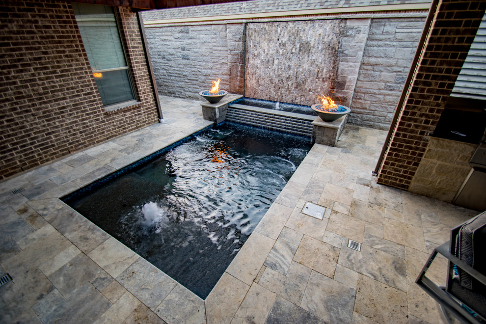 Small modern courtyard rectangular pool in Dallas with a hot tub and natural stone pavers.