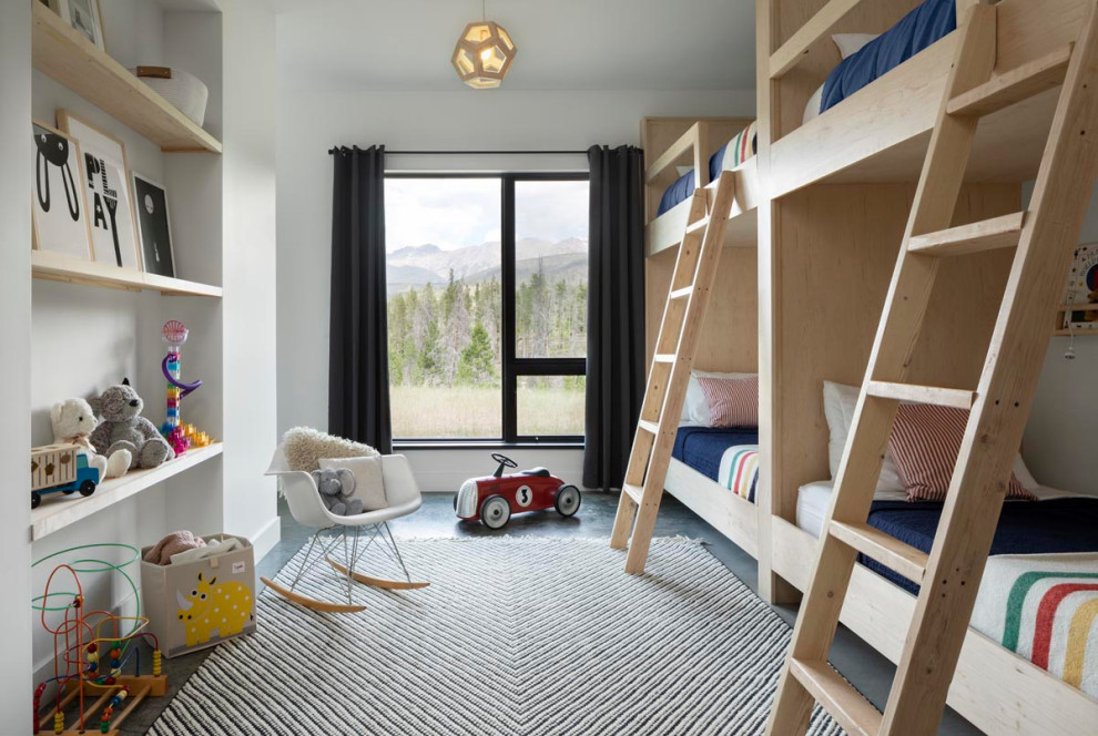 Imagen de dormitorio infantil escandinavo con paredes blancas y suelo de cemento
