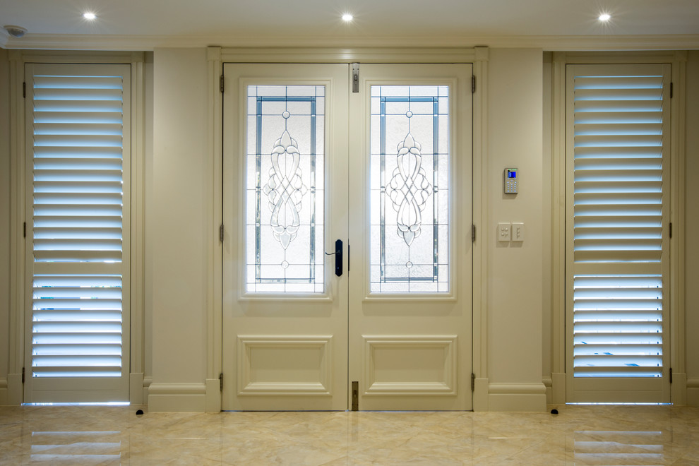 Design ideas for a mid-sized traditional front door in Sydney with grey walls, marble floors, a double front door and a white front door.