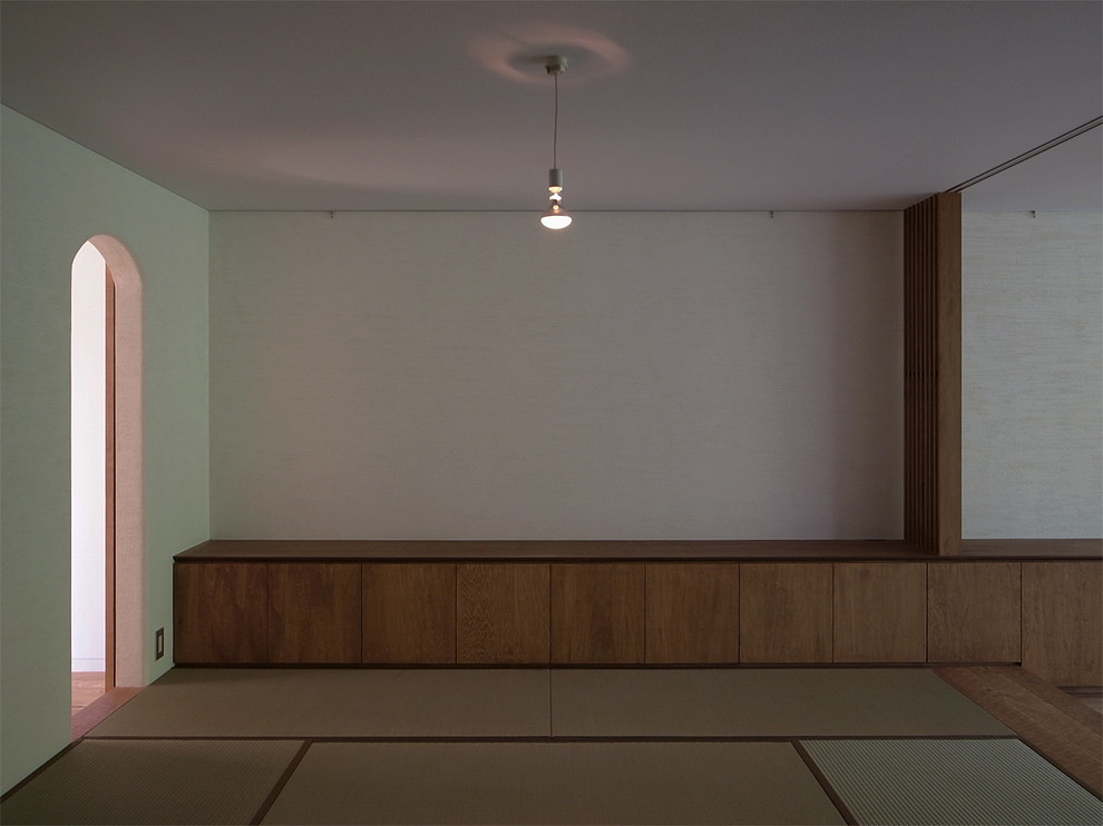 This is an example of an asian master bedroom in Yokohama with white walls and tatami floors.