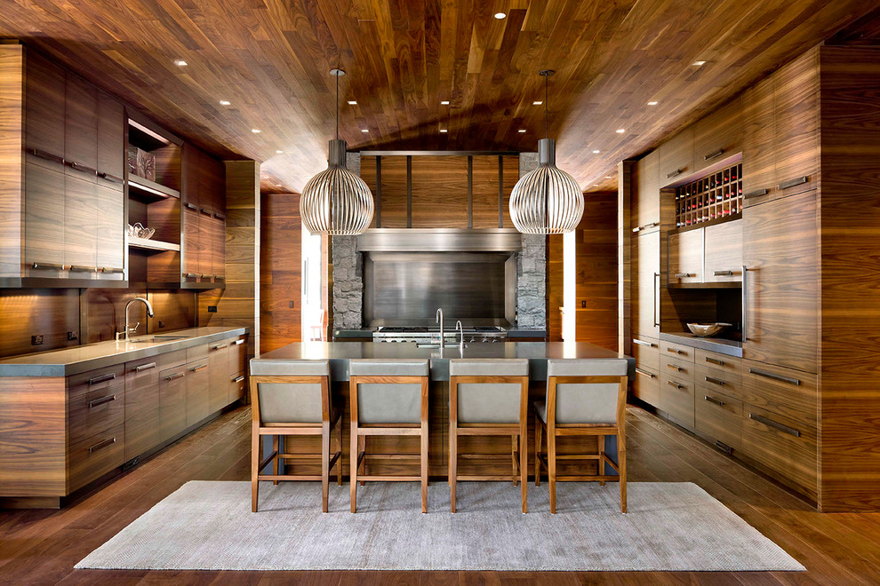 Inspiration for a large rustic u-shaped dark wood floor and brown floor eat-in kitchen remodel with an undermount sink, flat-panel cabinets, dark wood cabinets, metallic backsplash, stainless steel appliances, an island, solid surface countertops and metal backsplash
