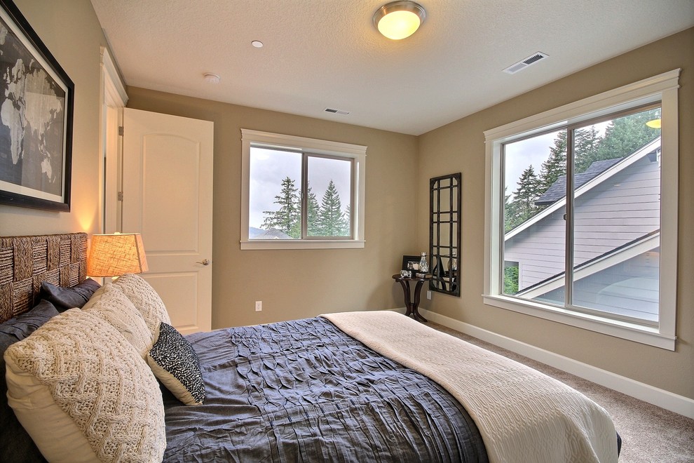 This is an example of a large transitional master bedroom in Portland with beige walls, carpet and no fireplace.