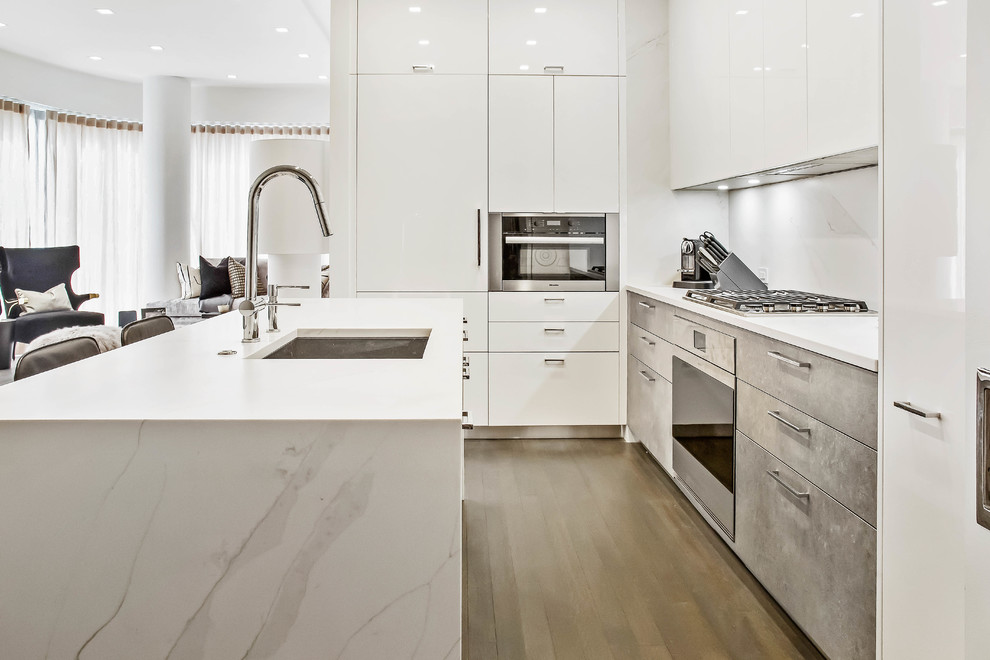 Mid-sized contemporary kitchen in New York with quartz benchtops, with island and white benchtop.