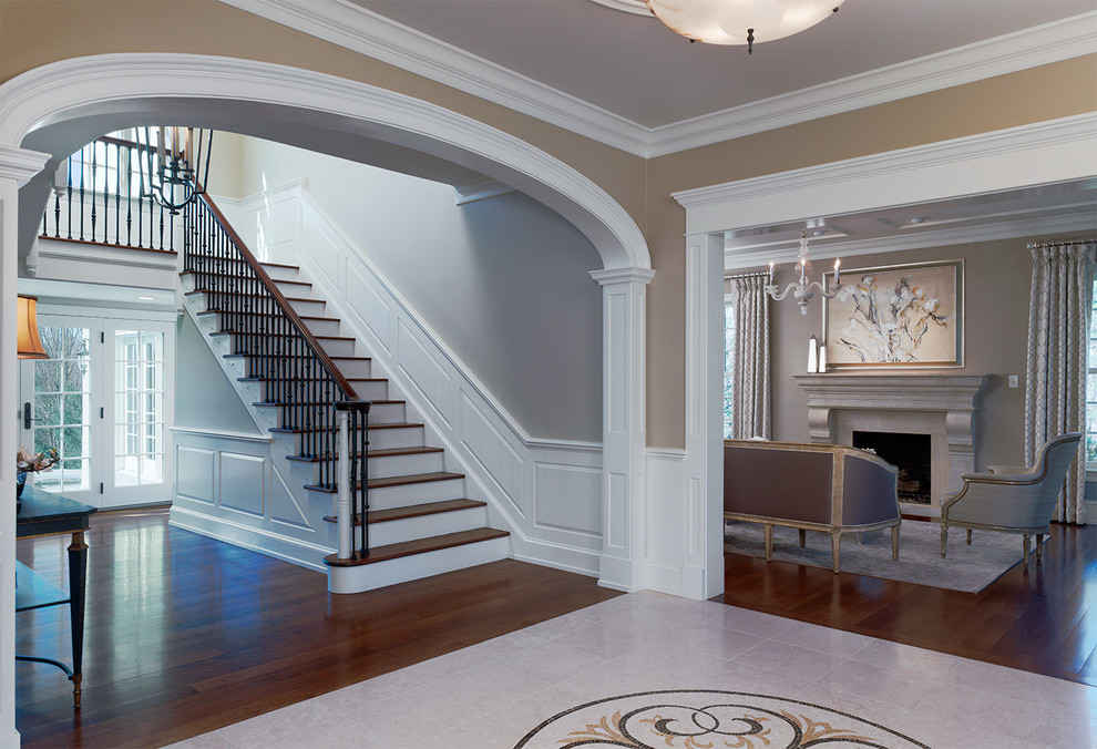Design ideas for a mid-sized transitional foyer in Philadelphia with beige walls, marble floors, a double front door and a dark wood front door.