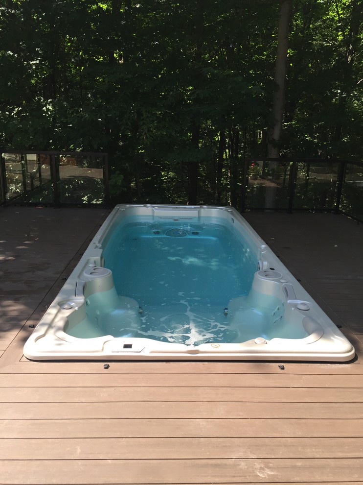 Inspiration for a traditional pool in Toronto with a hot tub and decking.