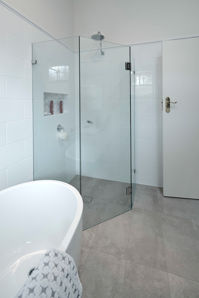 Design ideas for a small traditional master bathroom in Other with flat-panel cabinets, white cabinets, a freestanding tub, a corner shower, white tile, porcelain tile, white walls, porcelain floors, a vessel sink, marble benchtops, grey floor, a hinged shower door and multi-coloured benchtops.