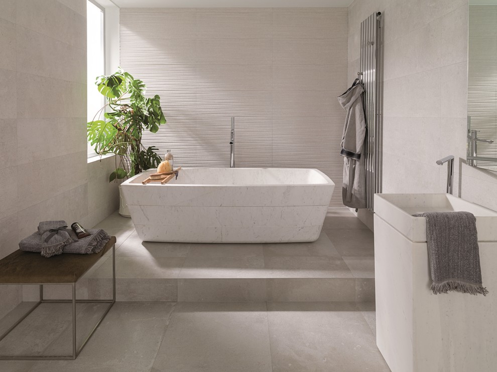 Photo of a contemporary master bathroom in Perth with a freestanding tub, white tile, ceramic tile, white walls, porcelain floors and a pedestal sink.