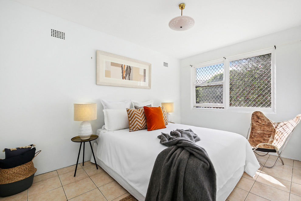 This is an example of a contemporary guest bedroom in Sydney with white walls and beige floor.