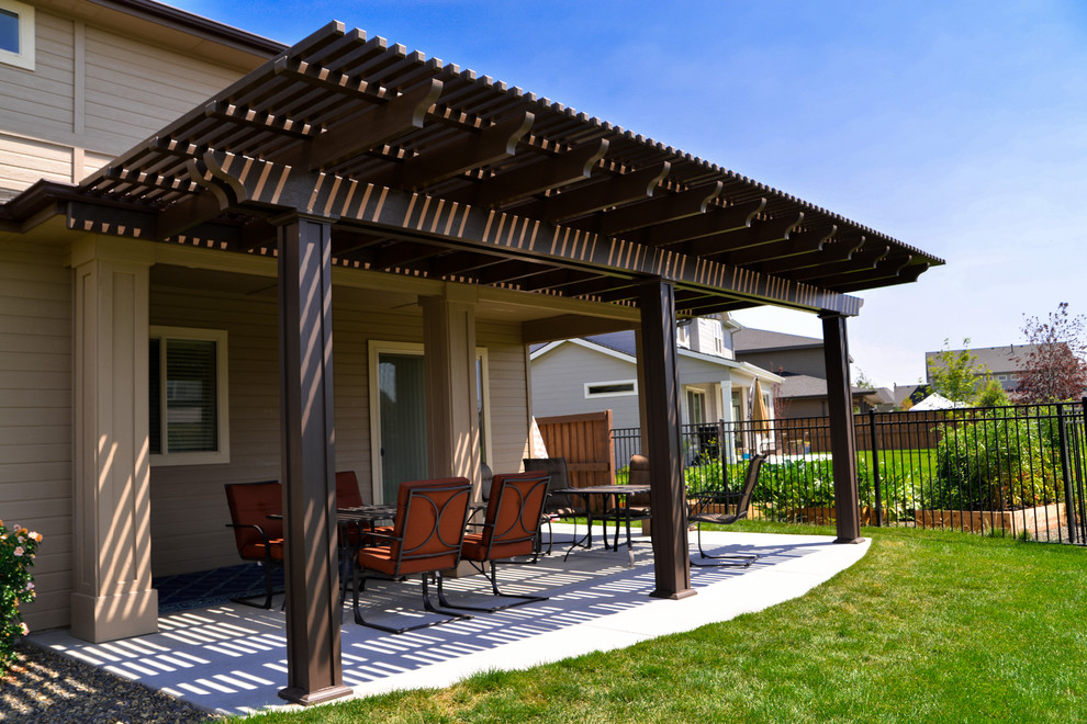 Patio - rustic backyard patio idea in Boise with a pergola