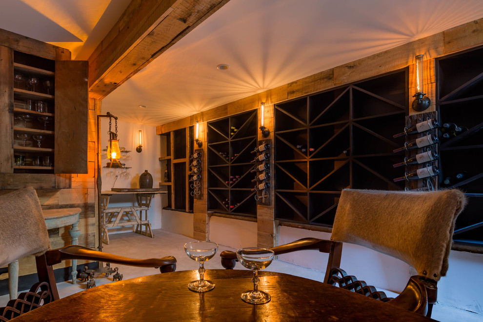 Wine cellar - cottage concrete floor wine cellar idea in Santa Barbara with display racks