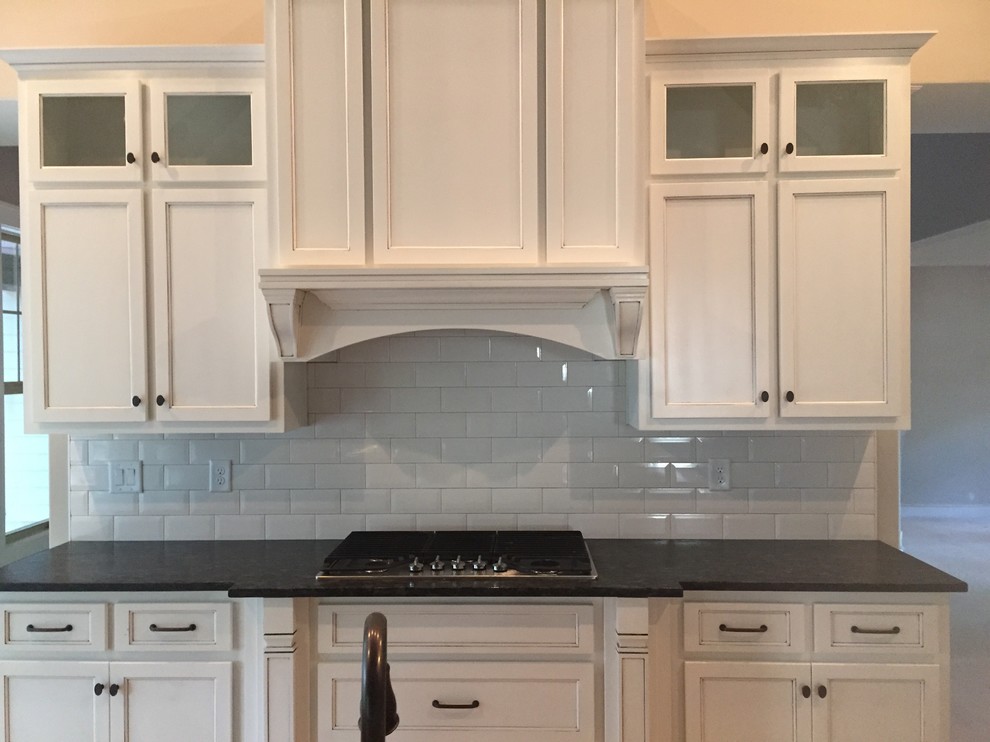 Inspiration for a mid-sized transitional kitchen remodel in Atlanta with recessed-panel cabinets, white cabinets, soapstone countertops, white backsplash and subway tile backsplash