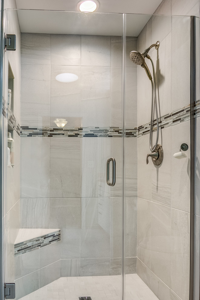 Drop-in bathtub - mid-sized transitional master gray tile and porcelain tile porcelain tile and gray floor drop-in bathtub idea in Chicago with recessed-panel cabinets, white cabinets, a two-piece toilet, blue walls, an undermount sink, solid surface countertops and a hinged shower door