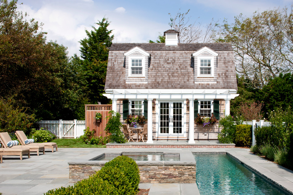 This is an example of a beach style lap pool in Boston with a pool house.