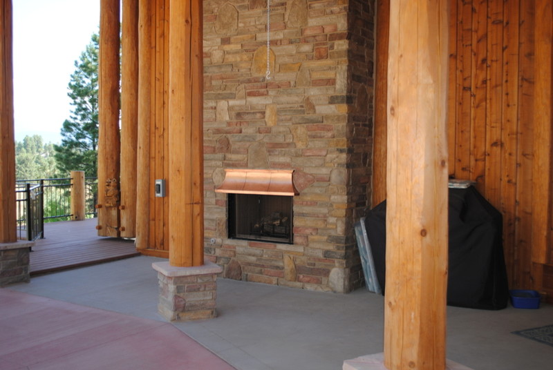 Inspiration for a huge rustic backyard concrete home design remodel in Denver with a fire pit and a roof extension
