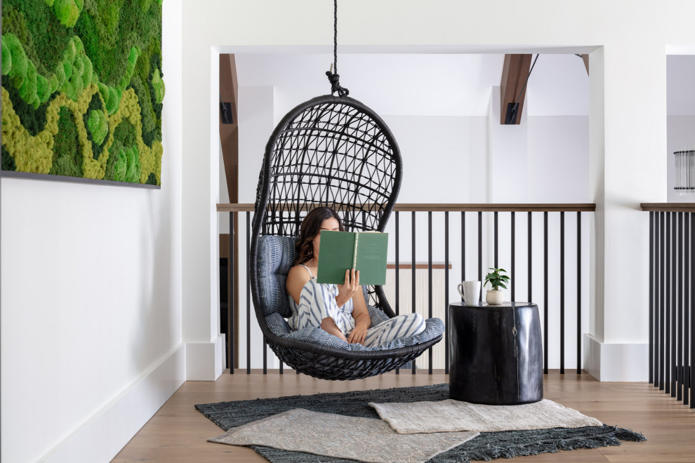 Whimsical Reading Nook with Hanging Swing Chair and Live Moss Wall Art - Located at the top of the grand staircase, this landing was used for a whimsical reading nook with a hanging swing chair, black wood side table, layered rugs, and a live moss art installation.