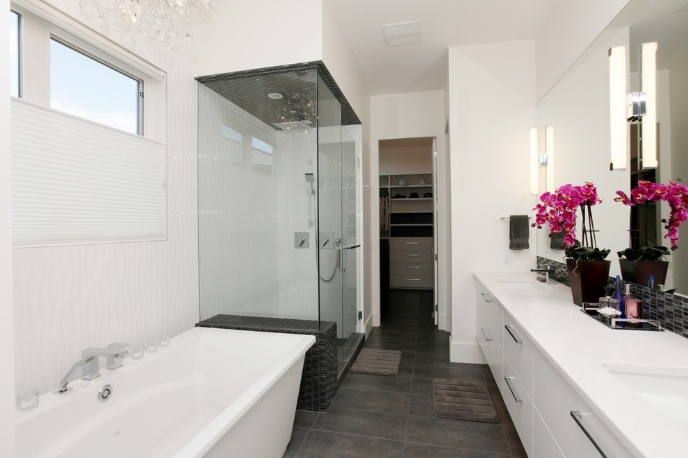 Design ideas for a large contemporary master bathroom in Vancouver with flat-panel cabinets, white cabinets, a freestanding tub, a corner shower, a two-piece toilet, black and white tile, glass sheet wall, white walls, light hardwood floors, an undermount sink and engineered quartz benchtops.
