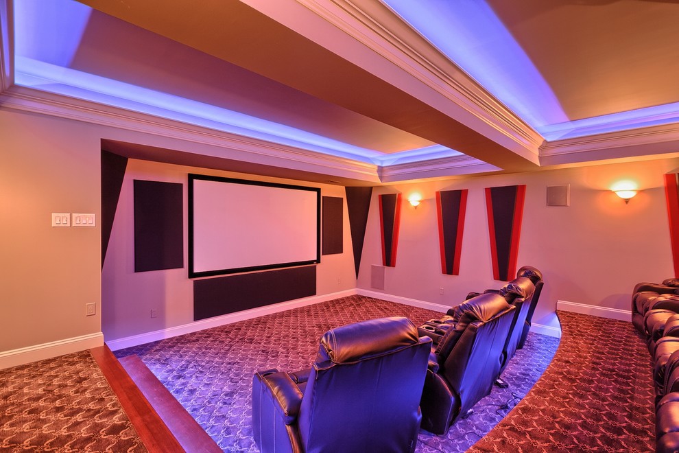 This is an example of a large traditional enclosed home theatre in St Louis with beige walls, carpet and a built-in media wall.