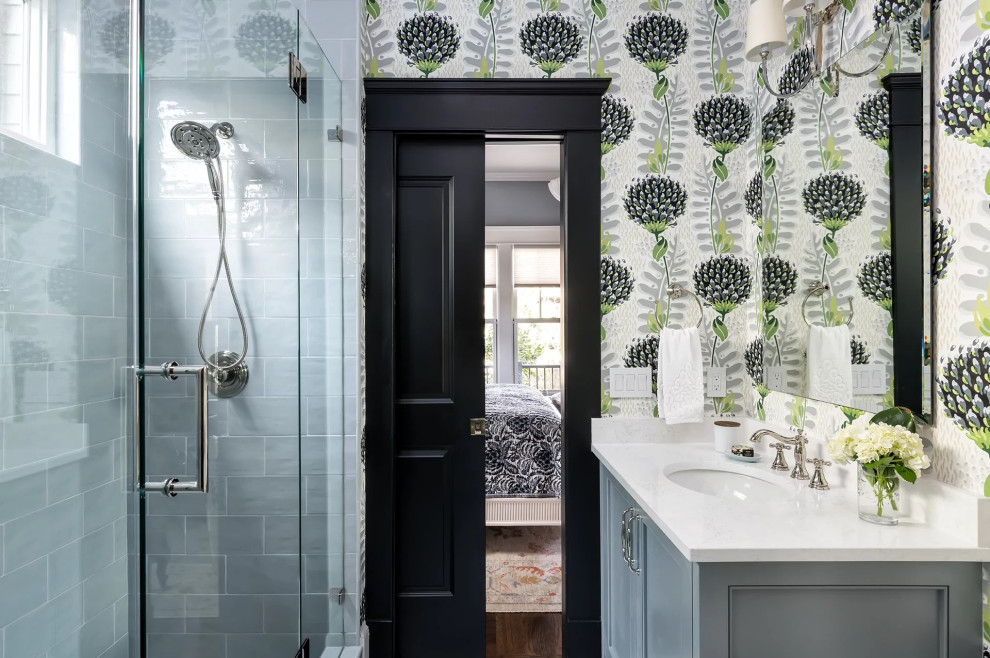 Photo of a small classic cloakroom in Philadelphia with recessed-panel cabinets, blue cabinets, a two-piece toilet, white tiles, metro tiles, green walls, marble flooring, a submerged sink, engineered stone worktops, white floors, white worktops, a freestanding vanity unit, a wallpapered ceiling and wallpapered walls.
