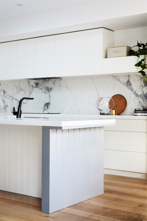 Intriguing Textures: White Kitchen Island Ideas with Beadboard Panels and Marble Backsplash
