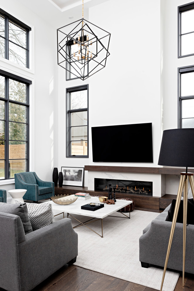 Photo of a large transitional open concept living room in Toronto with grey walls, dark hardwood floors, a standard fireplace, a stone fireplace surround, a wall-mounted tv, brown floor and recessed.