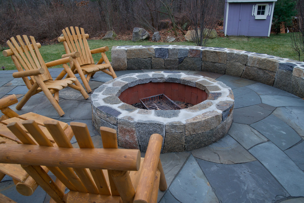 Design ideas for a large traditional backyard patio in Boston with a fire feature and natural stone pavers.