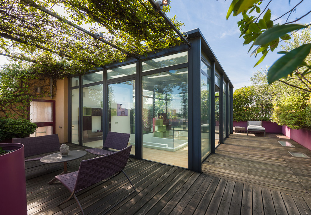 This is an example of a contemporary rooftop and rooftop deck in Milan with a container garden and a pergola.