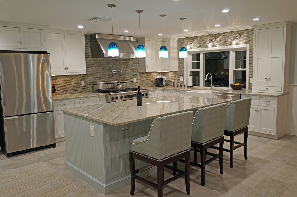 This is an example of a large transitional l-shaped eat-in kitchen in Boston with a farmhouse sink, recessed-panel cabinets, white cabinets, granite benchtops, brown splashback, glass tile splashback, stainless steel appliances, porcelain floors and with island.