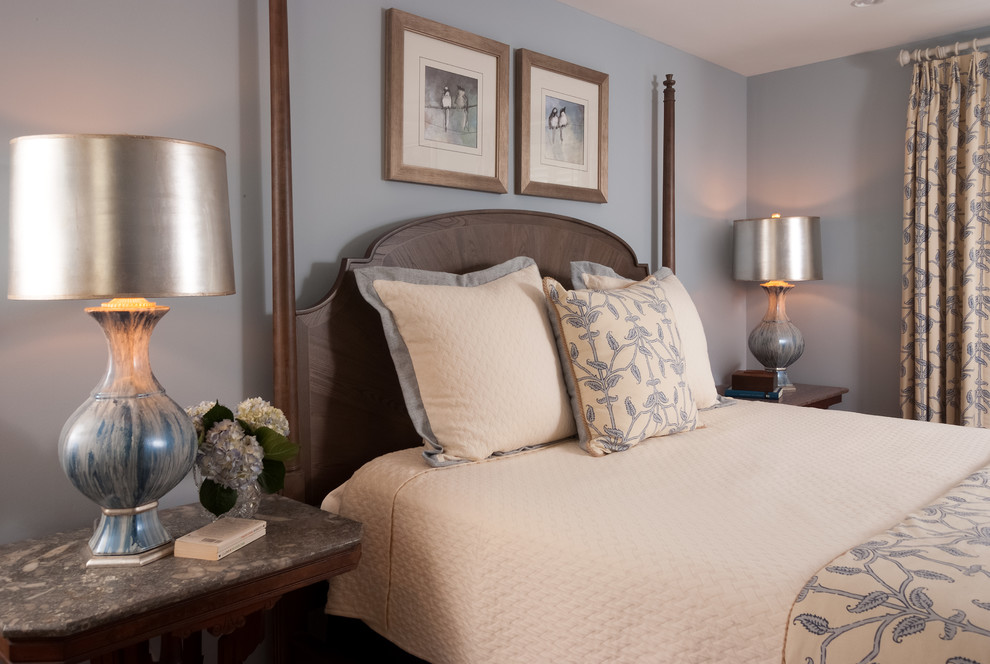 Mid-sized transitional master light wood floor and brown floor bedroom photo with gray walls