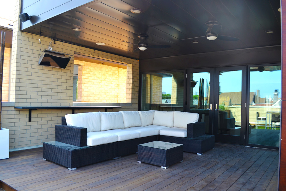 Inspiration for a mid-sized contemporary rooftop deck remodel in Chicago with a fire pit and a roof extension