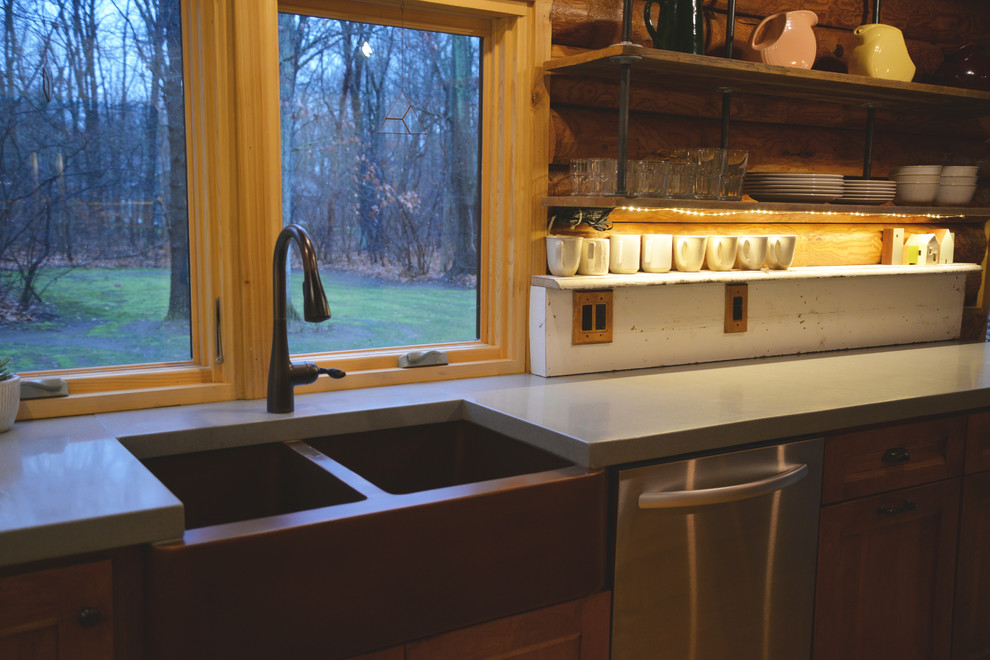 Example of a mid-sized mountain style galley light wood floor open concept kitchen design in Grand Rapids with an undermount sink, recessed-panel cabinets, medium tone wood cabinets, solid surface countertops, white backsplash, stainless steel appliances and an island