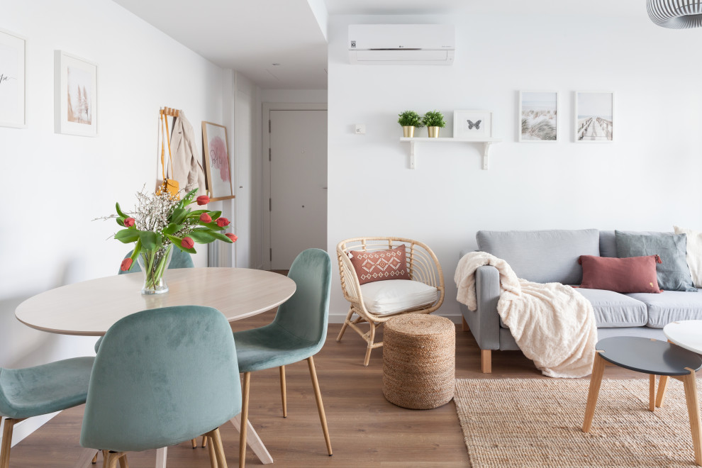 Inspiration for a medium sized scandi open plan living room in Madrid with white walls, medium hardwood flooring and brown floors.