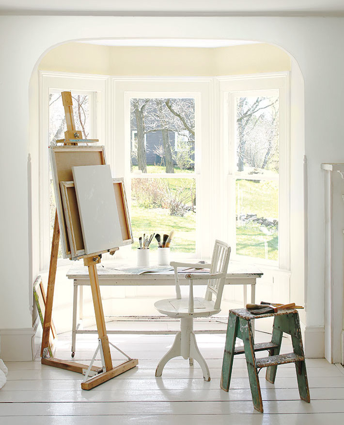 Mid-sized traditional craft room in Other with white walls, painted wood floors, a freestanding desk and white floor.
